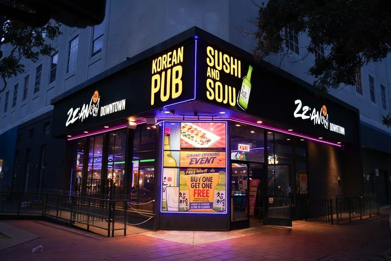 Zzan Downtown's neon corner storefront at night: Korean pub, sushi and soju