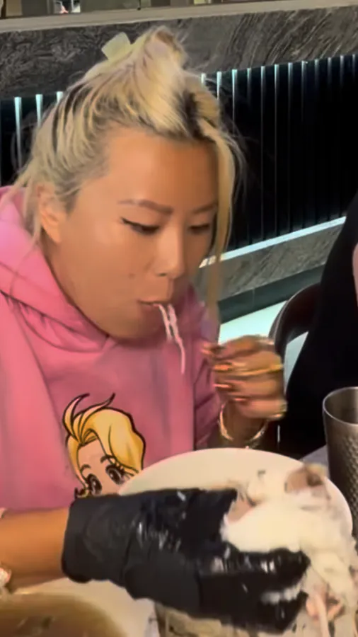 A contestant slurping pho noodles at the Pho Leo pho eating contest, from a reel by @rainaiscrazy